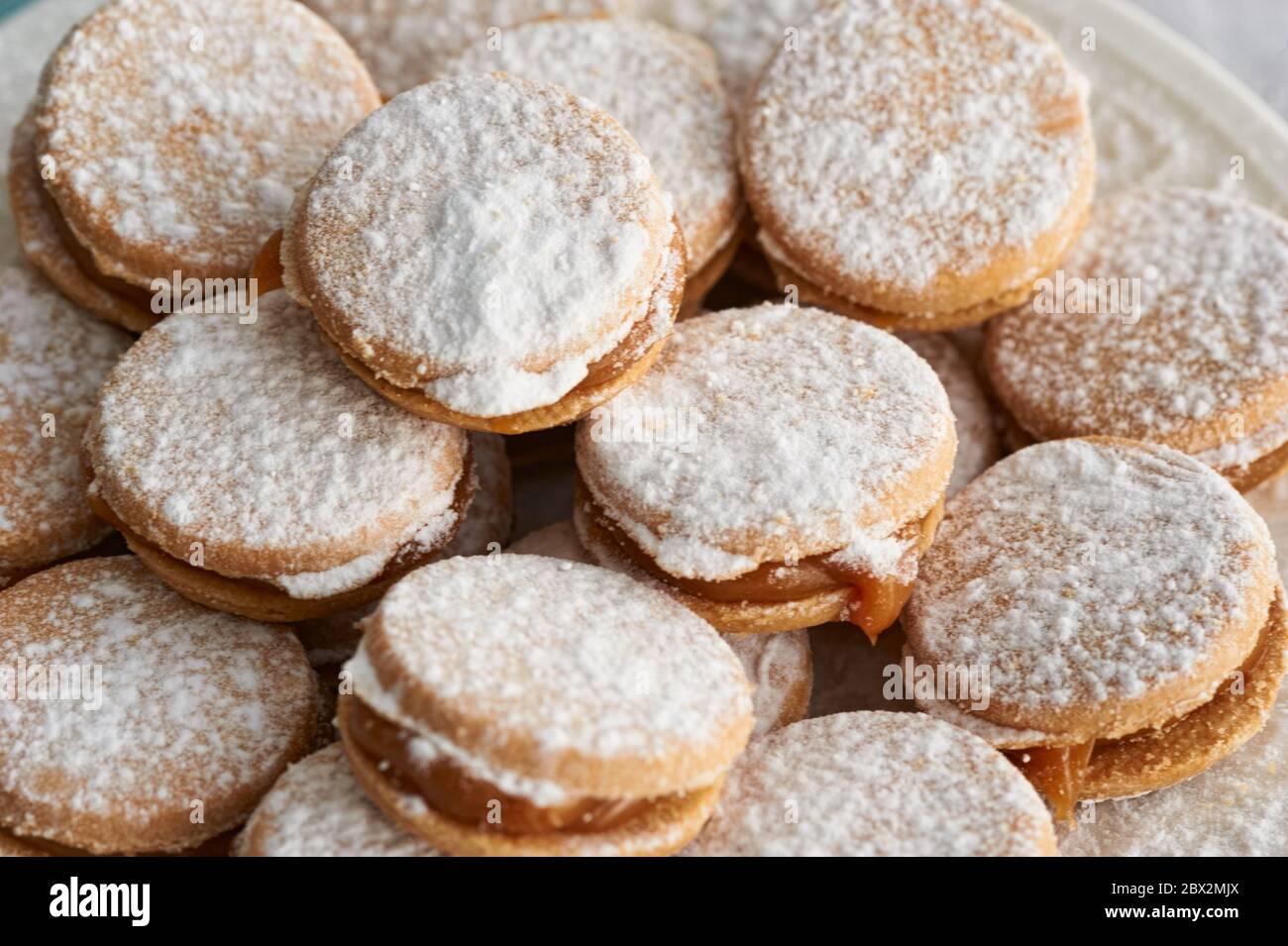 Alfajores: Traditional Peruvian cookies filled with caramel and white sugar dust on top. Stock Photo
