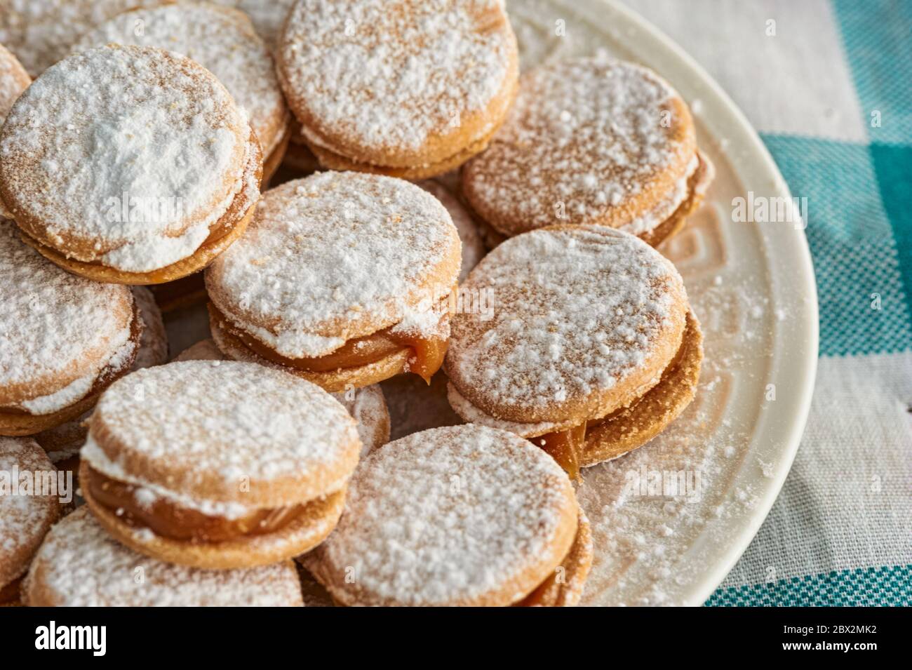 Alfajores: Traditional Peruvian cookies filled with caramel and white sugar dust on top. Stock Photo