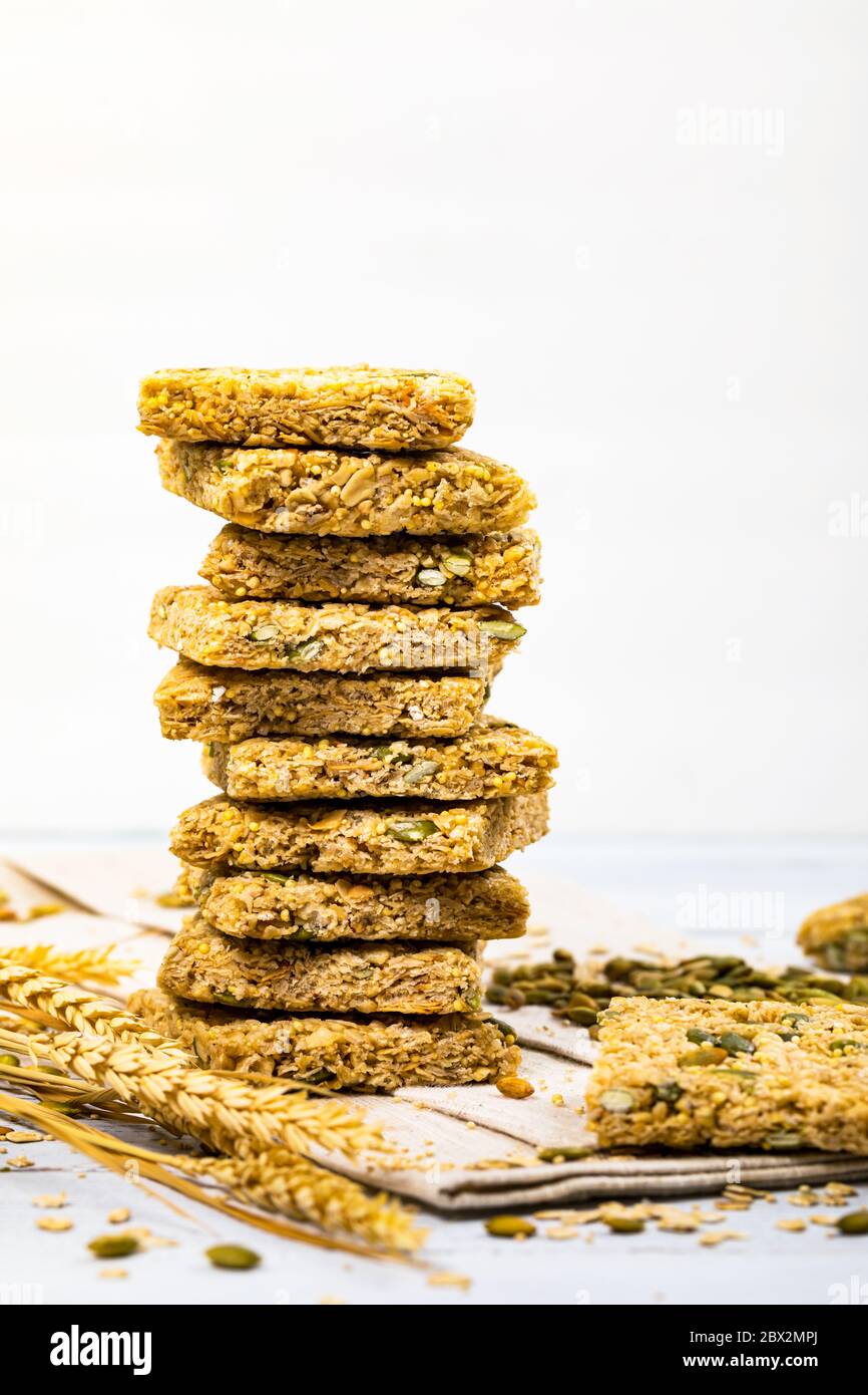 Multigrain Cereal Crunchy Squares Bars with Pumpkin Seeds Background. Healthy Bar Snack on White Background Stock Photo