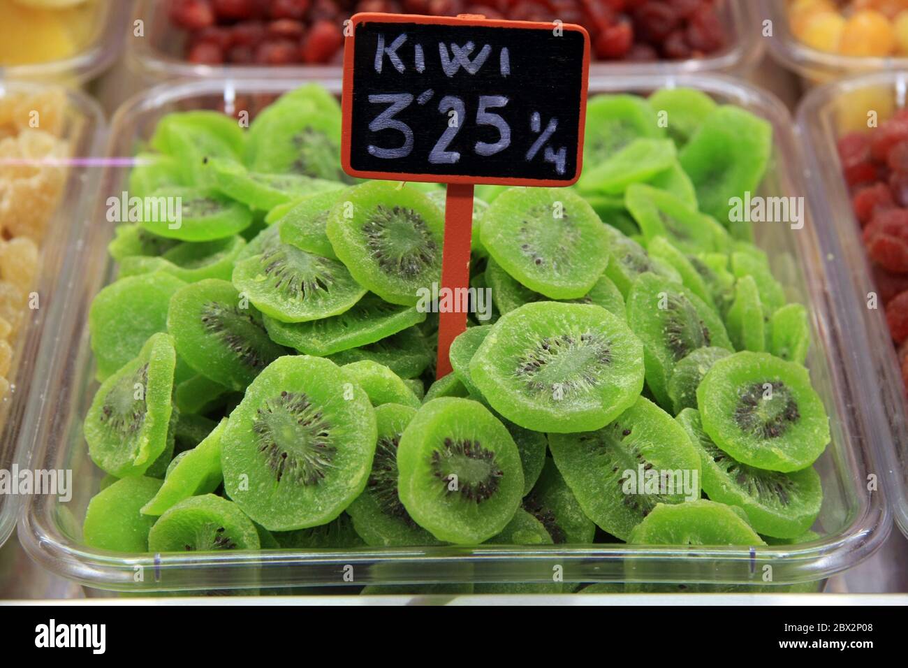 Dried kiwi in plastic container close up on a market stall in Europe Stock Photo