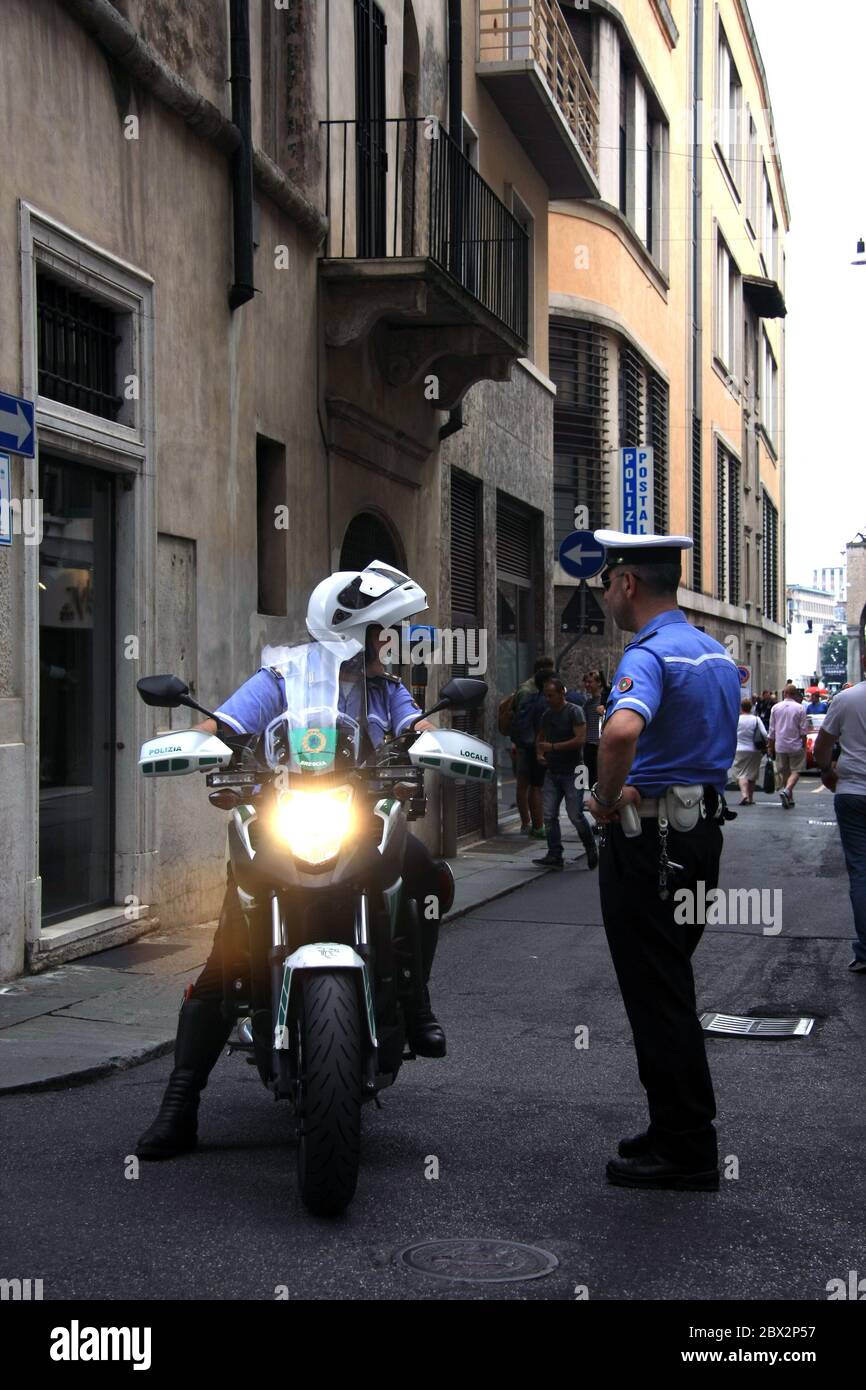 Brescia/Italy - May 18, 2017: Two Italian Police officers, one officer on motorbike talking to another Stock Photo