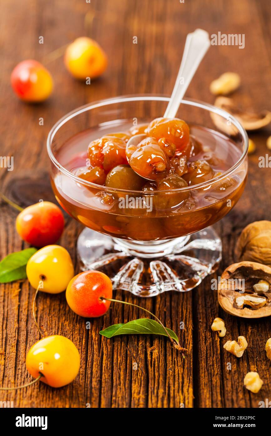 Cherry Jam with Nuts. Azerbaijani Cuisine White Cherry Preserves on Wooden Background. Stock Photo