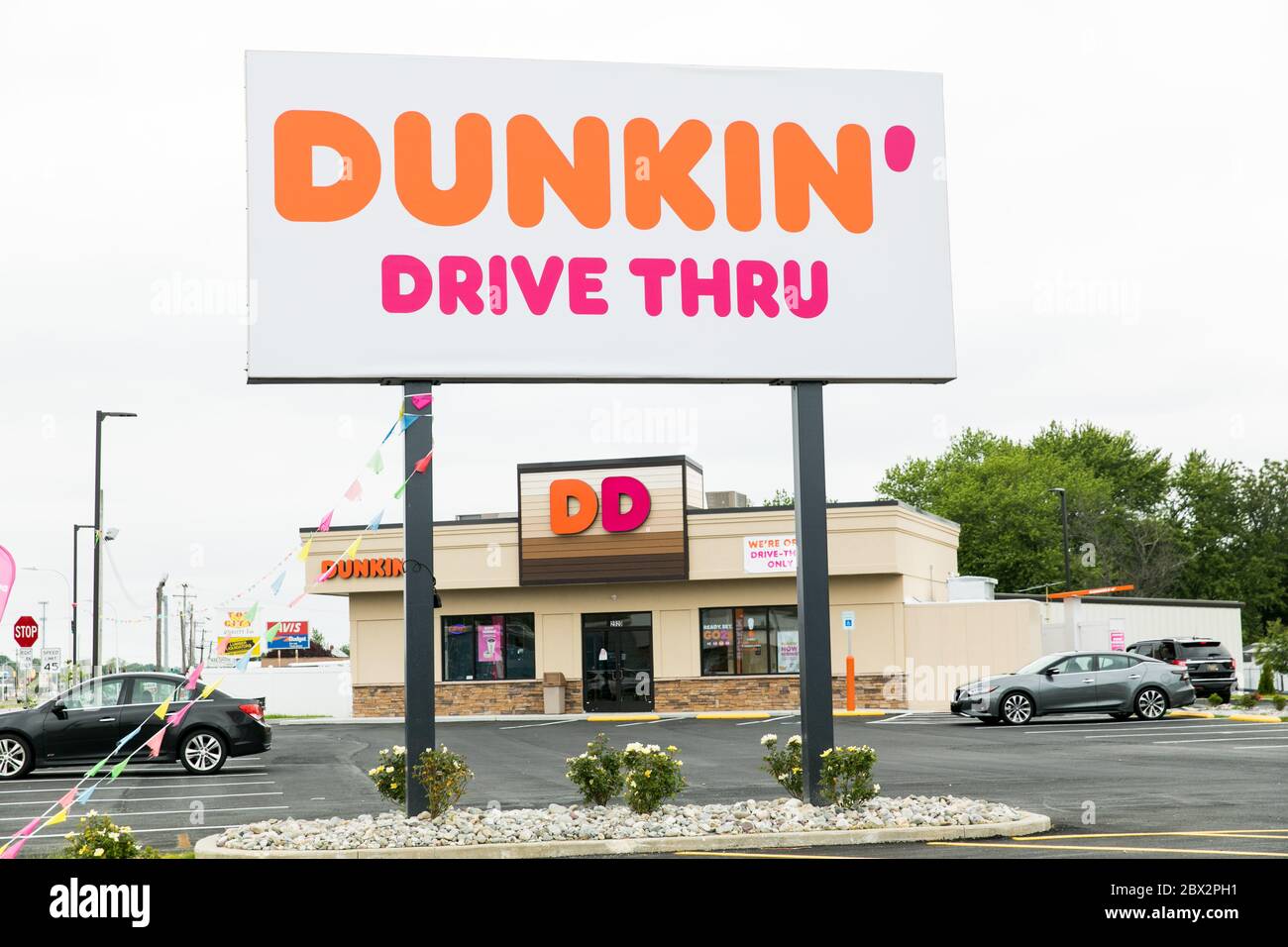 A logo sign outside of a Dunkin' Donuts restaurant location in Dover, Delaware on May 25, 2020. Stock Photo
