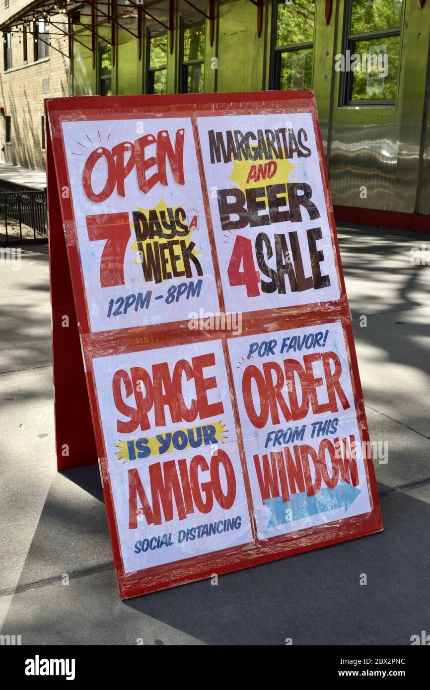 Sign advertising 'Margaritas and Beer 4 Sale' 'Space Is Your Amigo Social Distancing' 'Por Favor! Order From This Window', May 22, 2020, in New York. Stock Photo