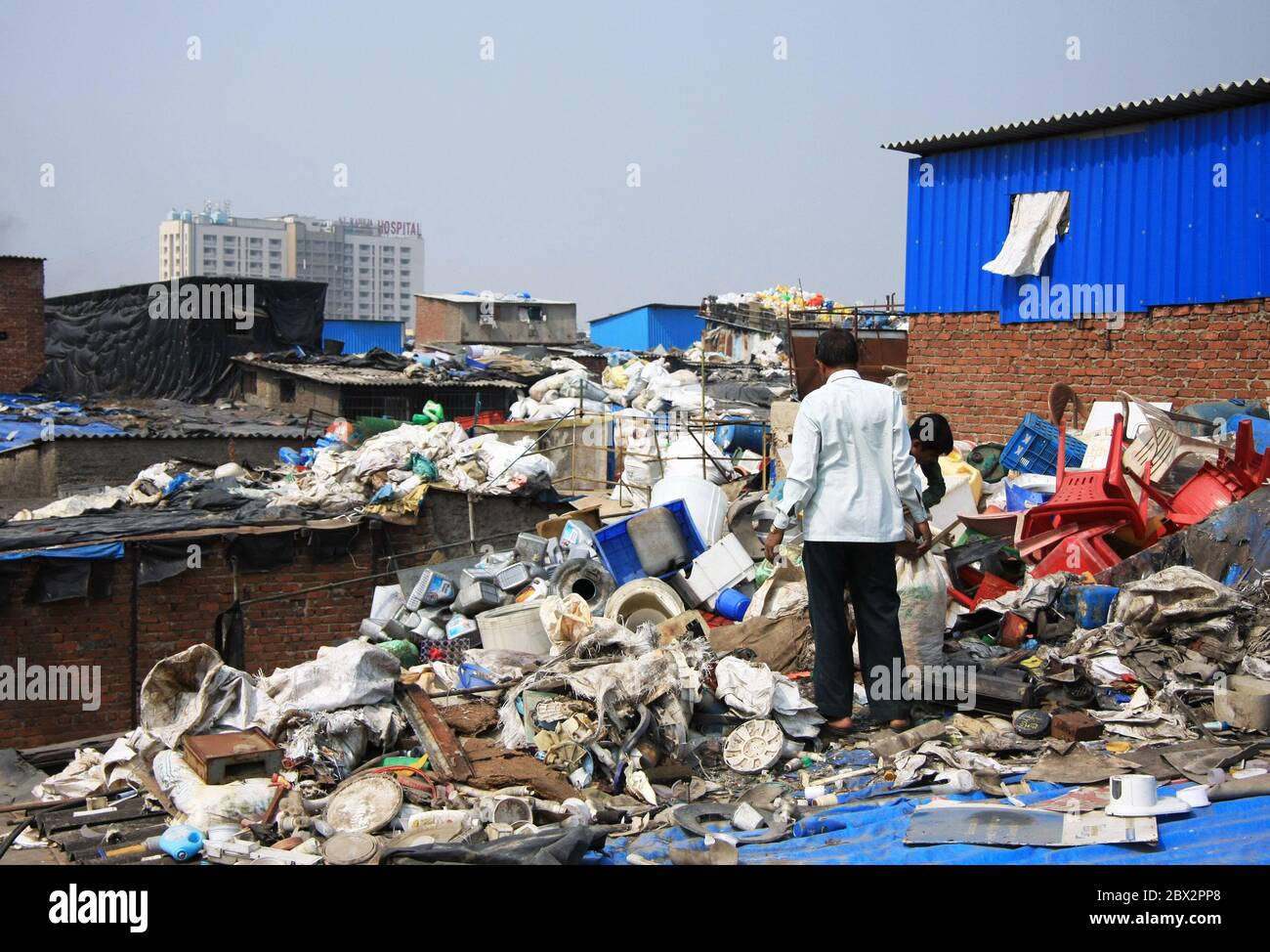 Mumbai, India - Dharavi slum waste rooftops with plastic waste and rubbish on hand-built slum living accommodation, in the middle of the city Stock Photo