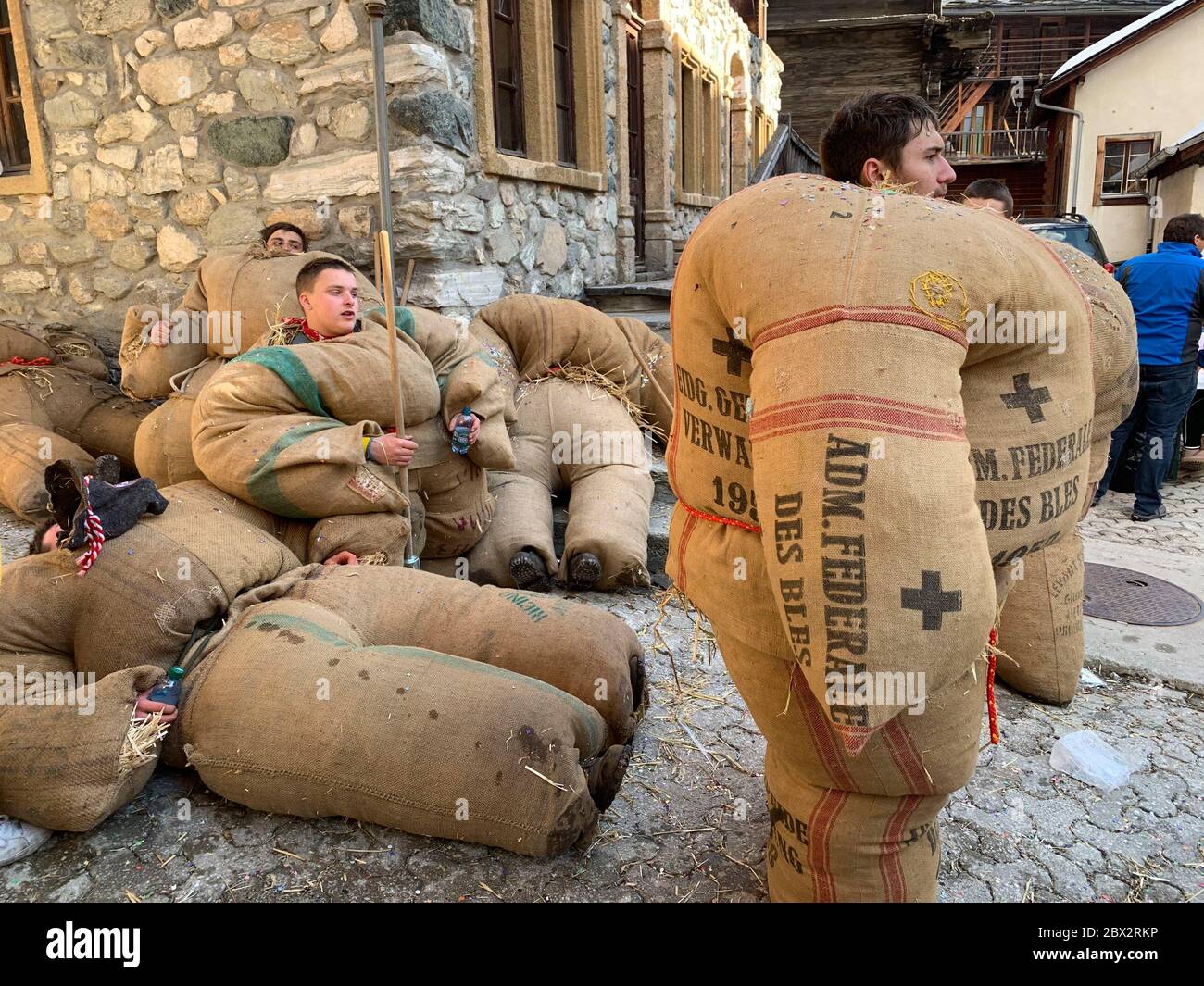 Switzerland, Valais (Wallis), Evolene 2020 Carnival, empaillés : according  a tradition in Val d'Herens, people masked with frightening wooden masks  are disguised with rough jute bags filled with straw, very uncomfortable and