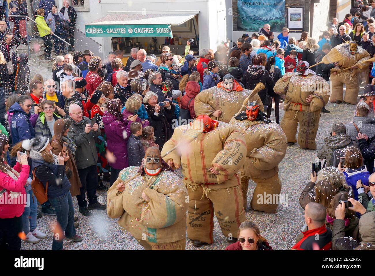 Switzerland, Valais (Wallis), Evolene 2020 Carnival, empaillés : according  a tradition in Val d'Herens, people masked with frightening wooden masks  are disguised with rough jute bags filled with straw, very uncomfortable and