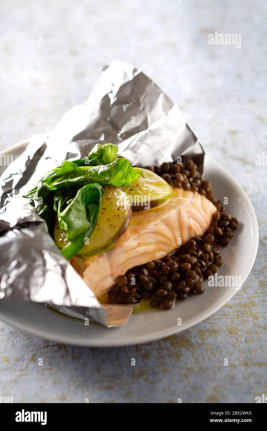 Papillote salmon spinach lentils with lime Stock Photo