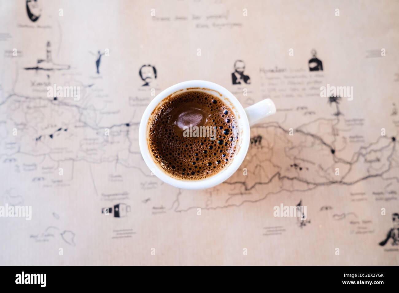 Top Down Image of Greek Coffee on a Table with a Map of Crete Stock Photo