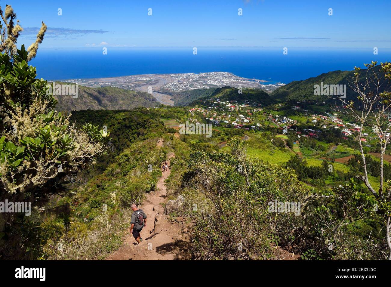 France, Reunion island (French overseas department), Reunion National Park listed as World heritage by UNESCO, La Possession, around village of Dos d'Ane, Roche Bouteille hike by the Cap Noir trail, the Rivière des Galets on the West Coast in the background Stock Photo