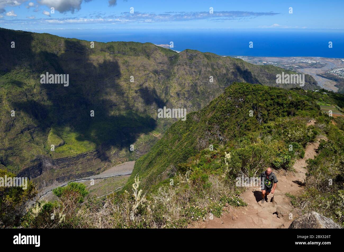 France, Reunion island (French overseas department), Reunion National Park listed as World heritage by UNESCO, La Possession, around village of Dos d'Ane, Roche Bouteille hike by the Cap Noir trail, the Rivière des Galets below and on the west coast in the background Stock Photo