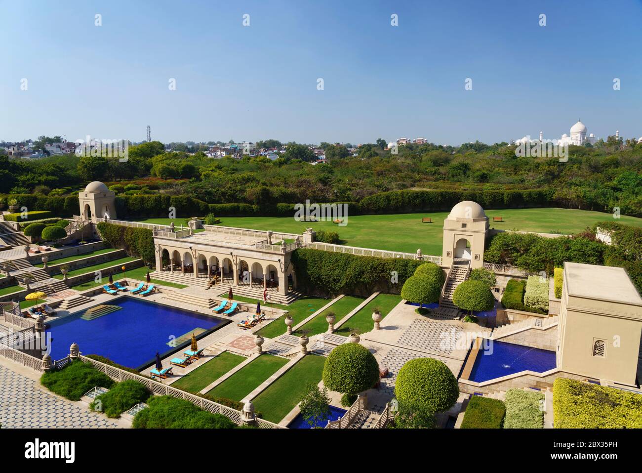 View over pool of luxury Oberoi Amavillas hotel overlooking Taj Mahal in Agra, India Stock Photo