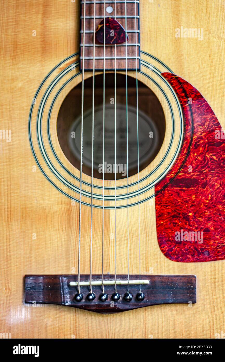 Nashville Acoustic Guitar Sound Hole, slanted with strings and detail of wood grain and design Stock Photo