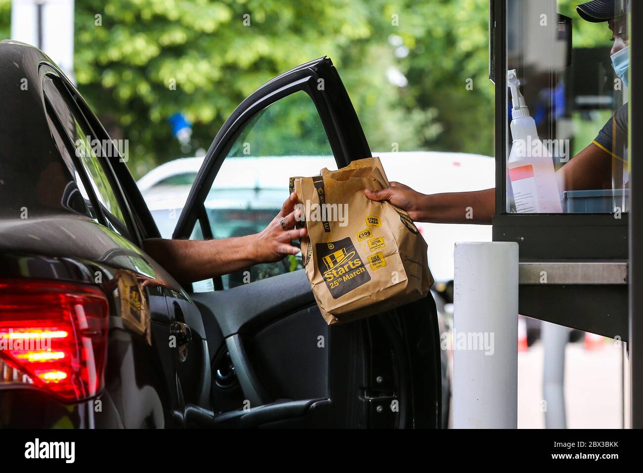 London, UK 4 June 2020 - A McDonald's Drive Thru staff wearing a face ...