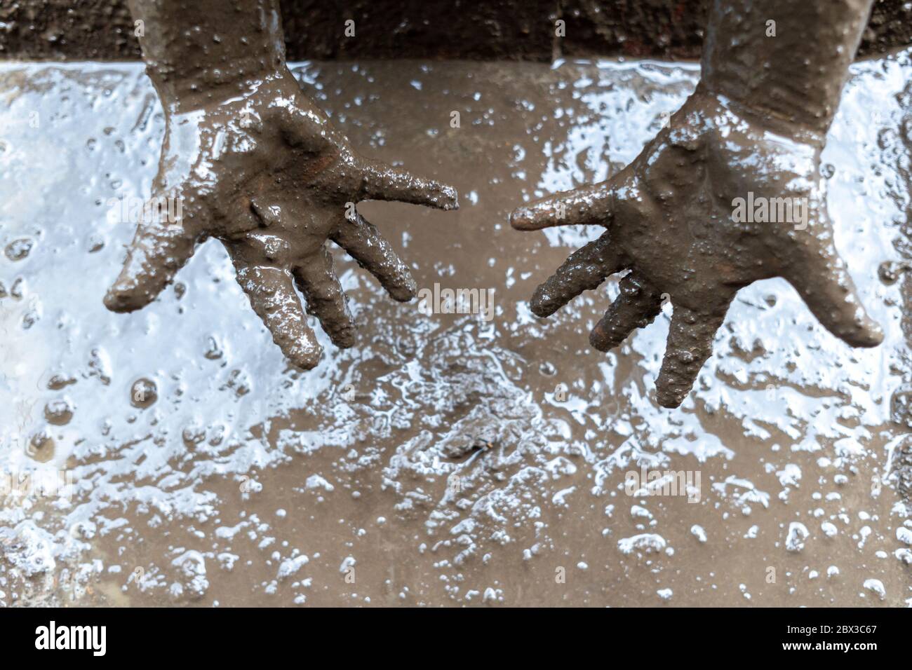 Child dirty hands mud hires stock photography and images Alamy