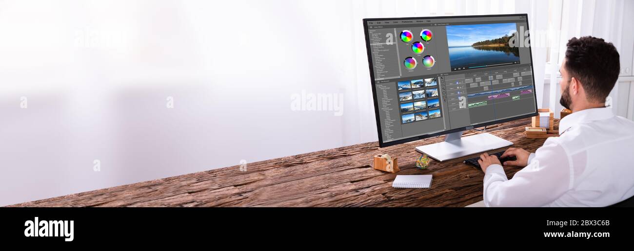 Video Editing On Desktop Computer. Designer Person Stock Photo