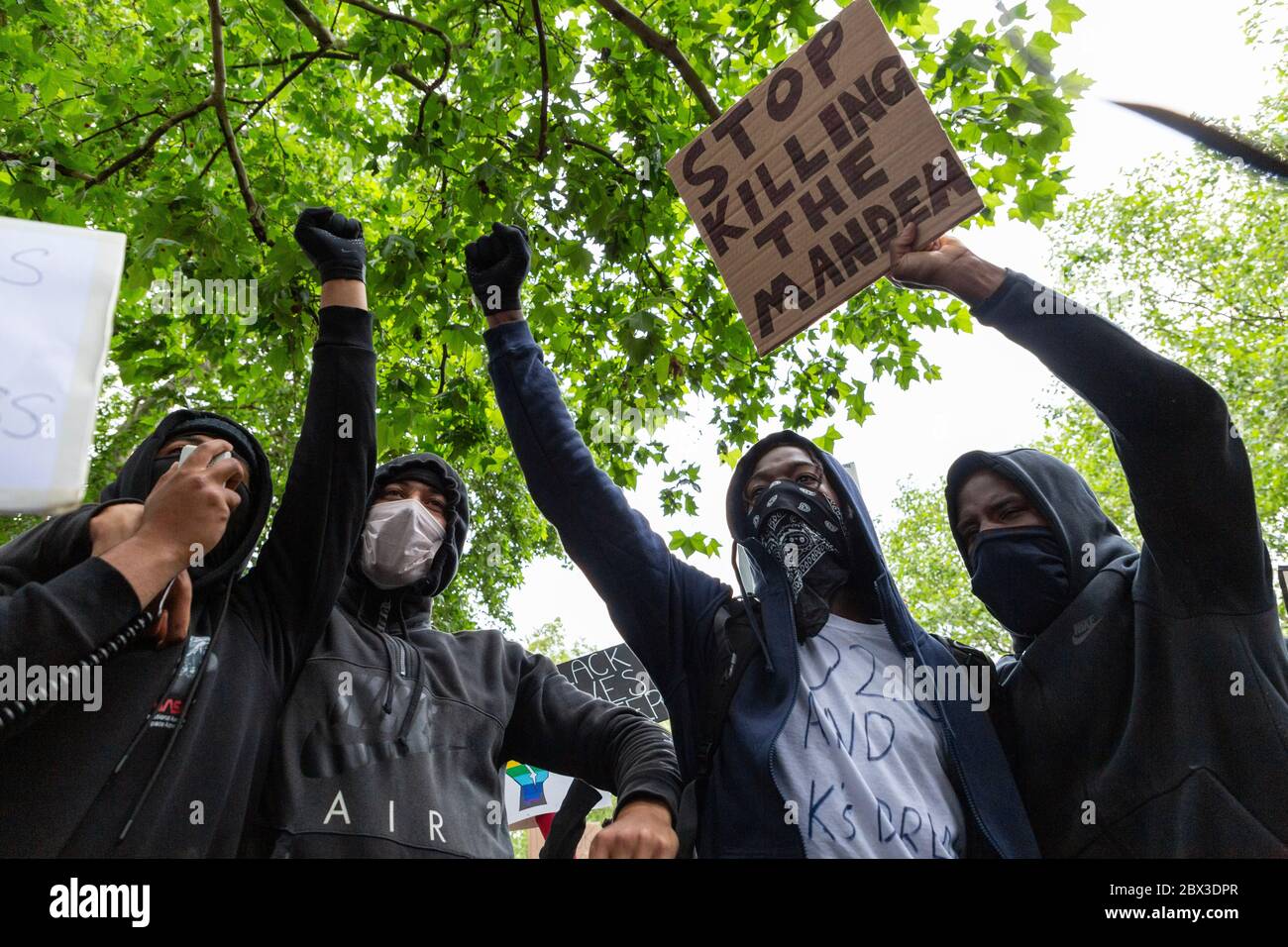 Young men with their arms raised at the Black Lives Matters protest in Hyde Park, London, 3 June 2020 Stock Photo