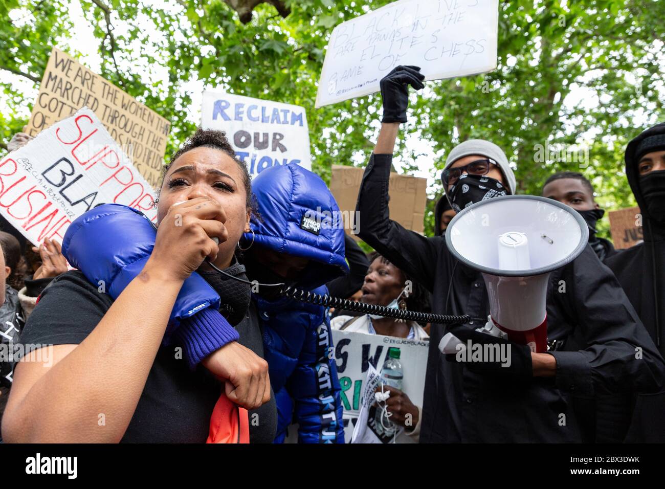 A woman giving an emotional speech via a loudspeaker at the Black Lives Matters protest in Hyde Park, London, 3 June 2020 Stock Photo