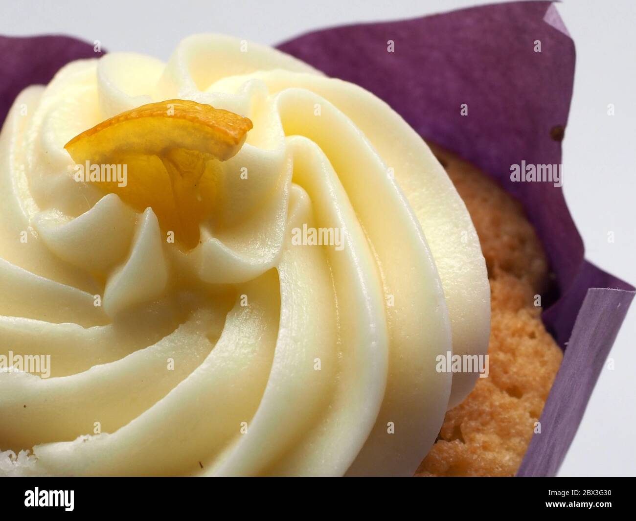 Close Up Of An Iced Cupcake Decorated With A Wedge Of Lemon, London, UK. Stock Photo