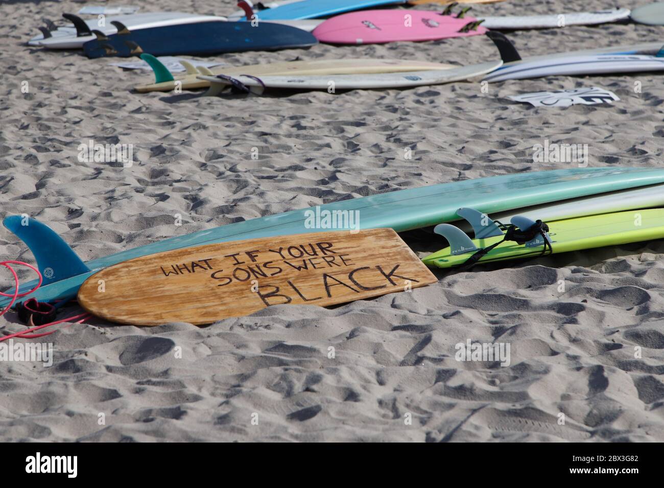 Surfboards on the beach in Encinitas, CA at a Black Lives Matter