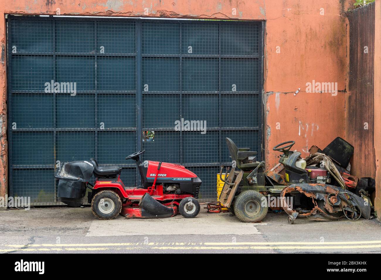 Scrap Ride-on Lawnmowers at a repair shop in Bandon, West Cork, Ireland. Stock Photo