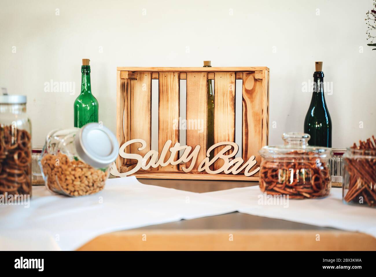 Salty bar of several kinds snacks decorated on wooden table. Closeup of  lettering: "Salty Bar". Wedding or party concept Stock Photo - Alamy