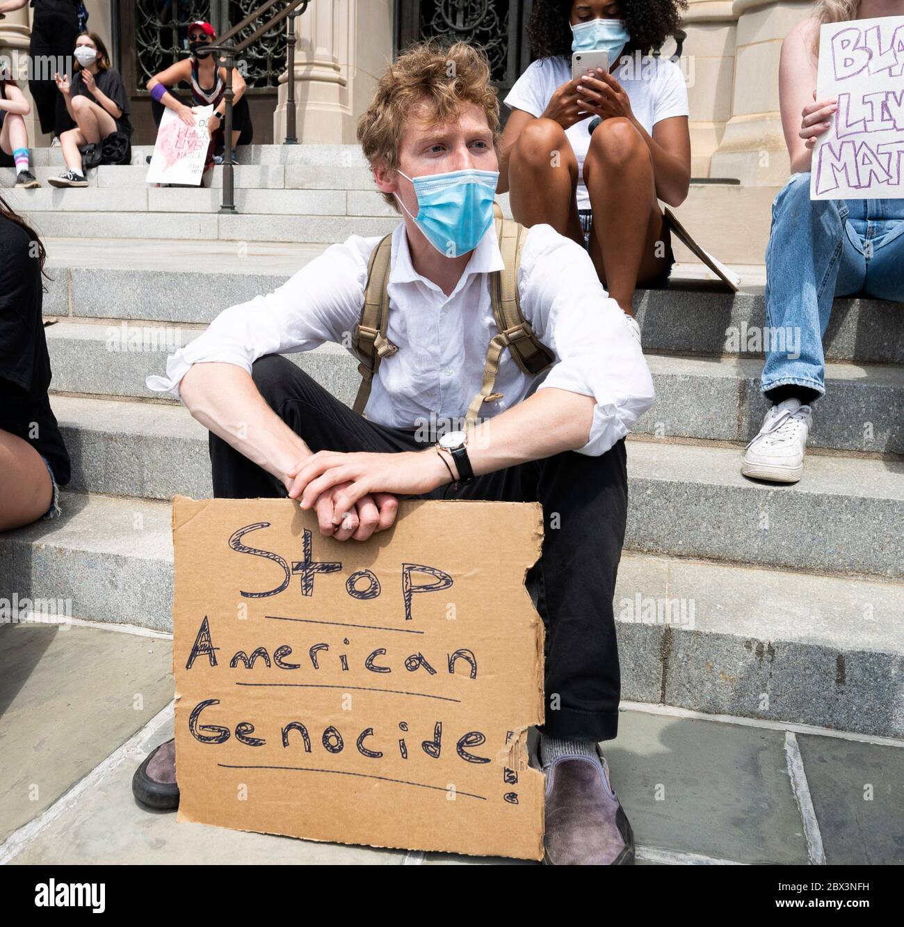 Washington, DC, USA. 4th June, 2020. June 4, 2020 - Washington, DC, United States: Man with ''Stop American Genocide!'' sign at a protest supporting Black Lives Matter at the National Cathedral. Credit: Michael Brochstein/ZUMA Wire/Alamy Live News Stock Photo