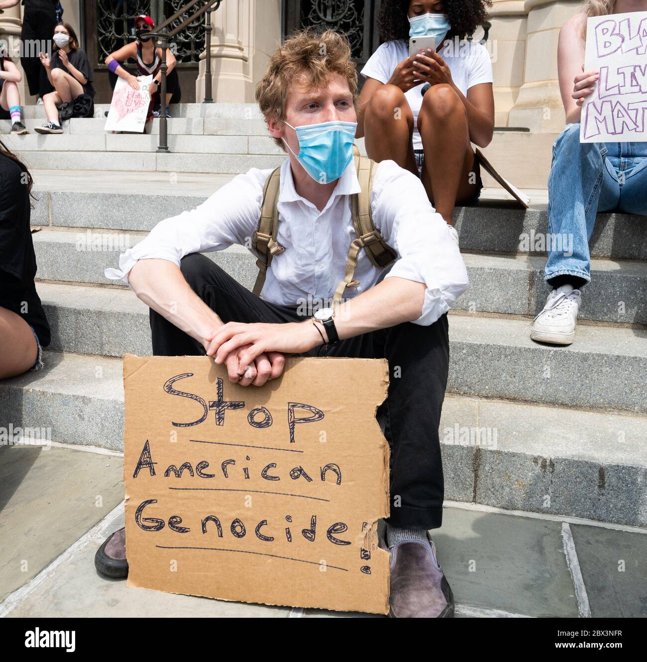 Washington, United States. 04th June, 2020. June 4, 2020 - Washington, DC, United States: Man with 'Stop American Genocide!' sign at a protest supporting Black Lives Matter at the National Cathedral. (Photo by Michael Brochstein/Sipa USA) Credit: Sipa USA/Alamy Live News Stock Photo
