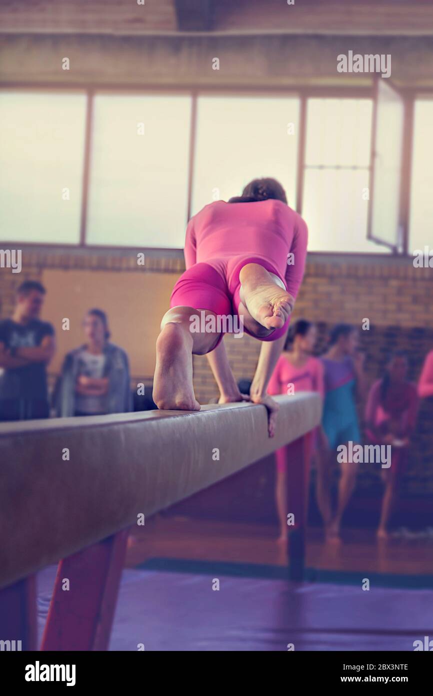 Young girl athlete gymnast on balance beam competition in gymnastics