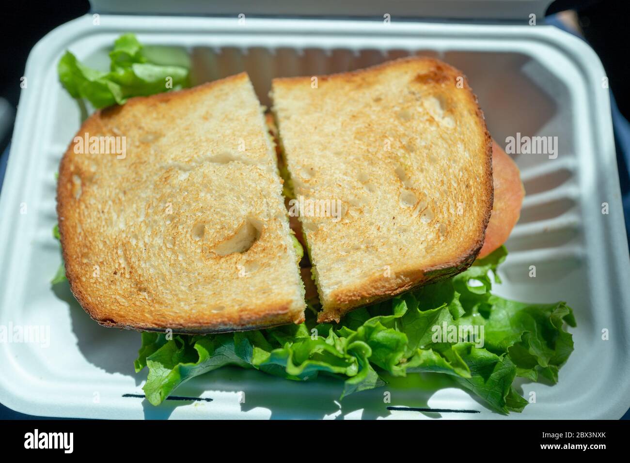 Sandwich on to go container from Boudin Bakery in Walnut Creek, California, an example of a restaurant providing takeout food during lockdowns related to an outbreak of the COVID-19 coronavirus, April 16, 2020. () Stock Photo