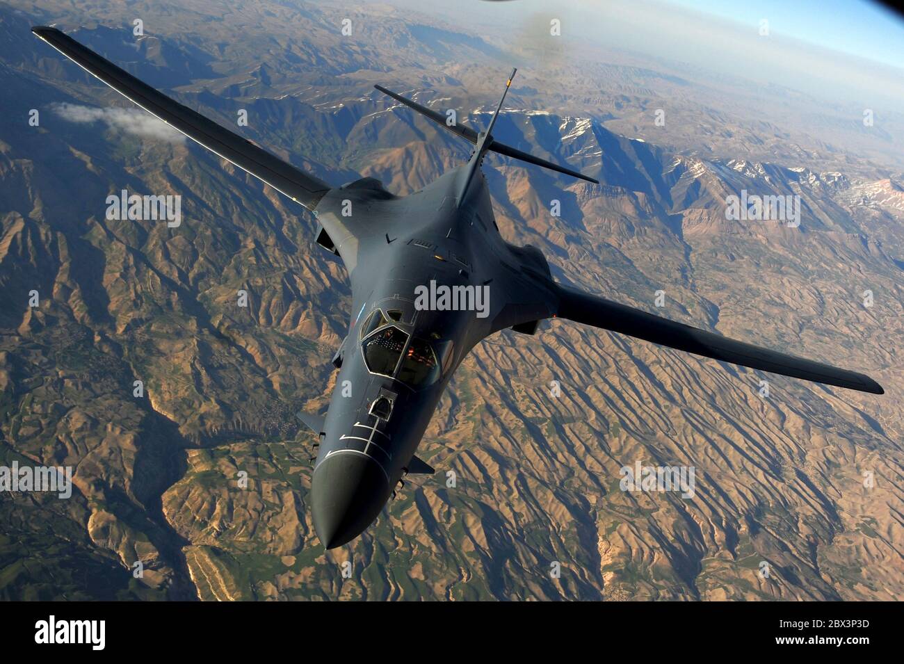 A U.S. Air Force B-1B Lancer stealth bomber aircraft from the 37th Expeditionary Bomb Squadron, of the 28th Bomb Wing, returns to mission after refueling from a KC-135 Stratotanker aircraft in support of Operation Enduring Freedom March 29, 2011 over Afghanistan. Stock Photo