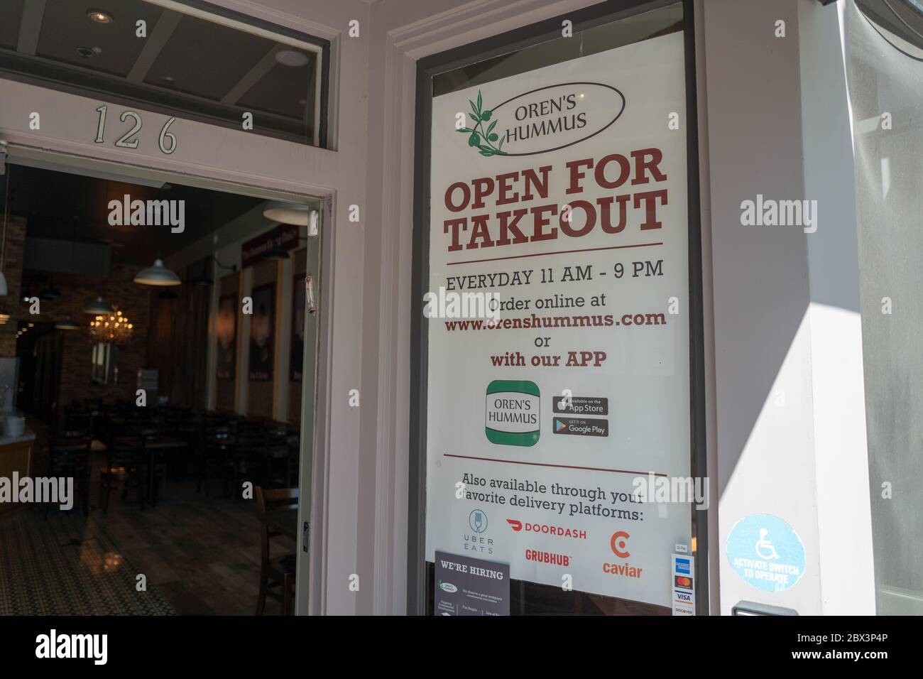 A Large Sign In The Window Of Oren S Hummus Reads Open For Takeout And Provides Takeout And Delivery Options In The Silicon Valley Mountain View California During An Outbreak Of The Covid 19