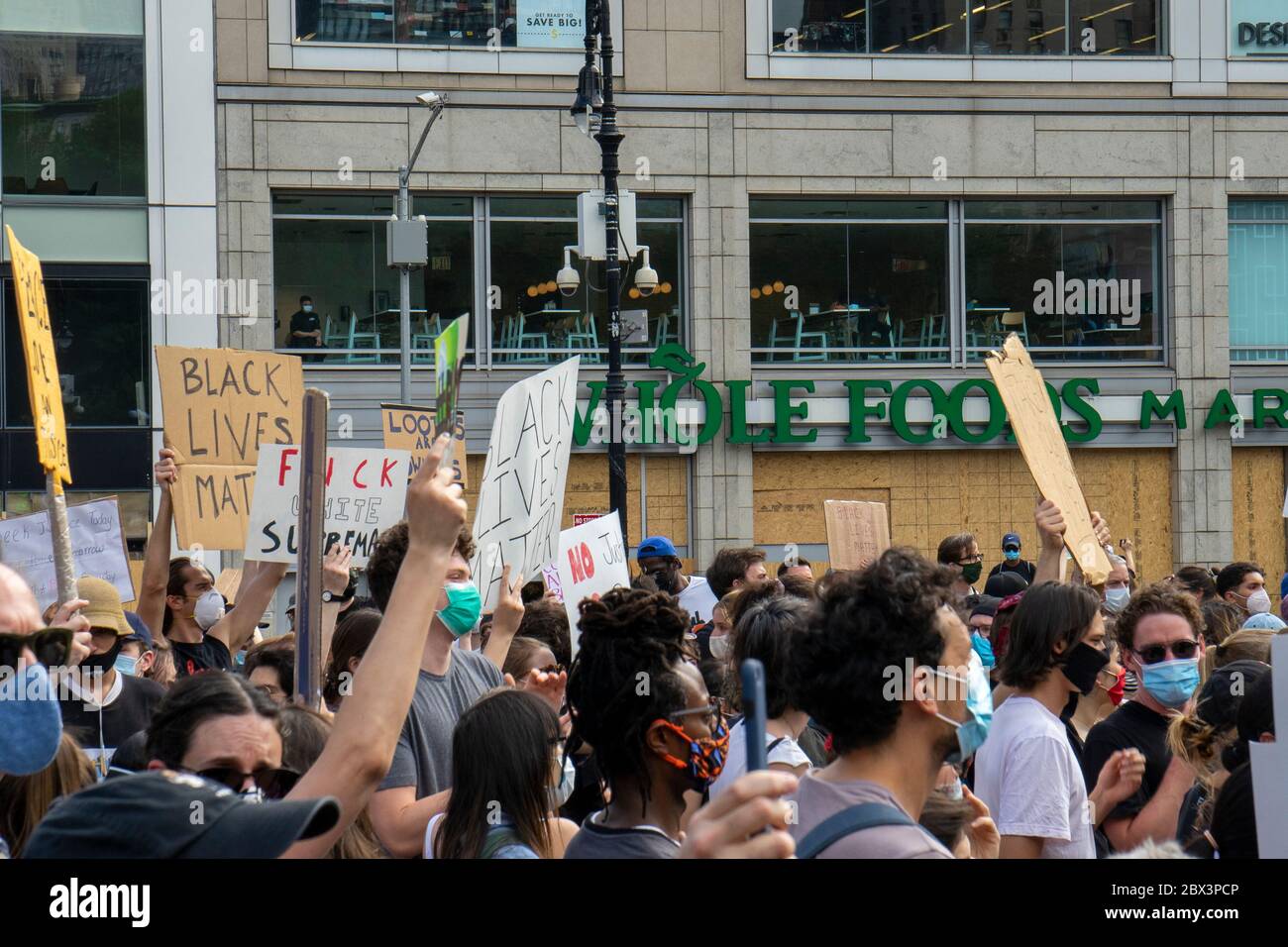Black Lives Matter protesters in front of a boarded up Whole Foods Market, Union Square, New York City, 4 June 2020 Stock Photo