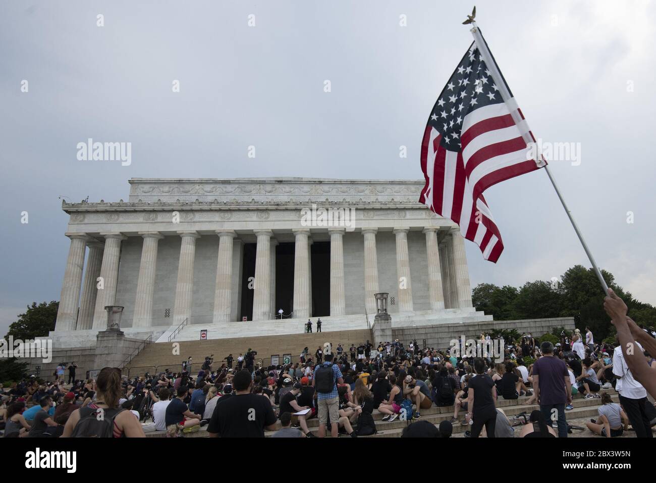 Washington, United States. 04th June, 2020. An American flag waves as protesters rally during a demonstration against police brutality and the death of George Floyd on Thursday, June 4, 2020 at the Lincoln Memorial in Washington, DC. Demonstrations sprang up in various locations in the Nation's Capital and in cities around the country over the death of George Floyd, who was killed in police custody in Minneapolis on May 25. The four officers involved have been charged. Photo by Pat Benic/UPI Credit: UPI/Alamy Live News Stock Photo