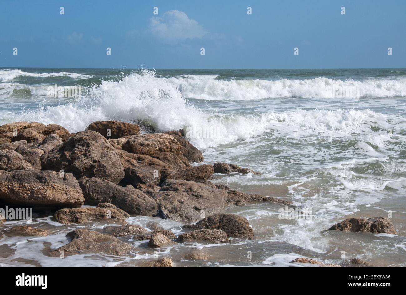 Waves crash on a rocky beach Stock Photo - Alamy