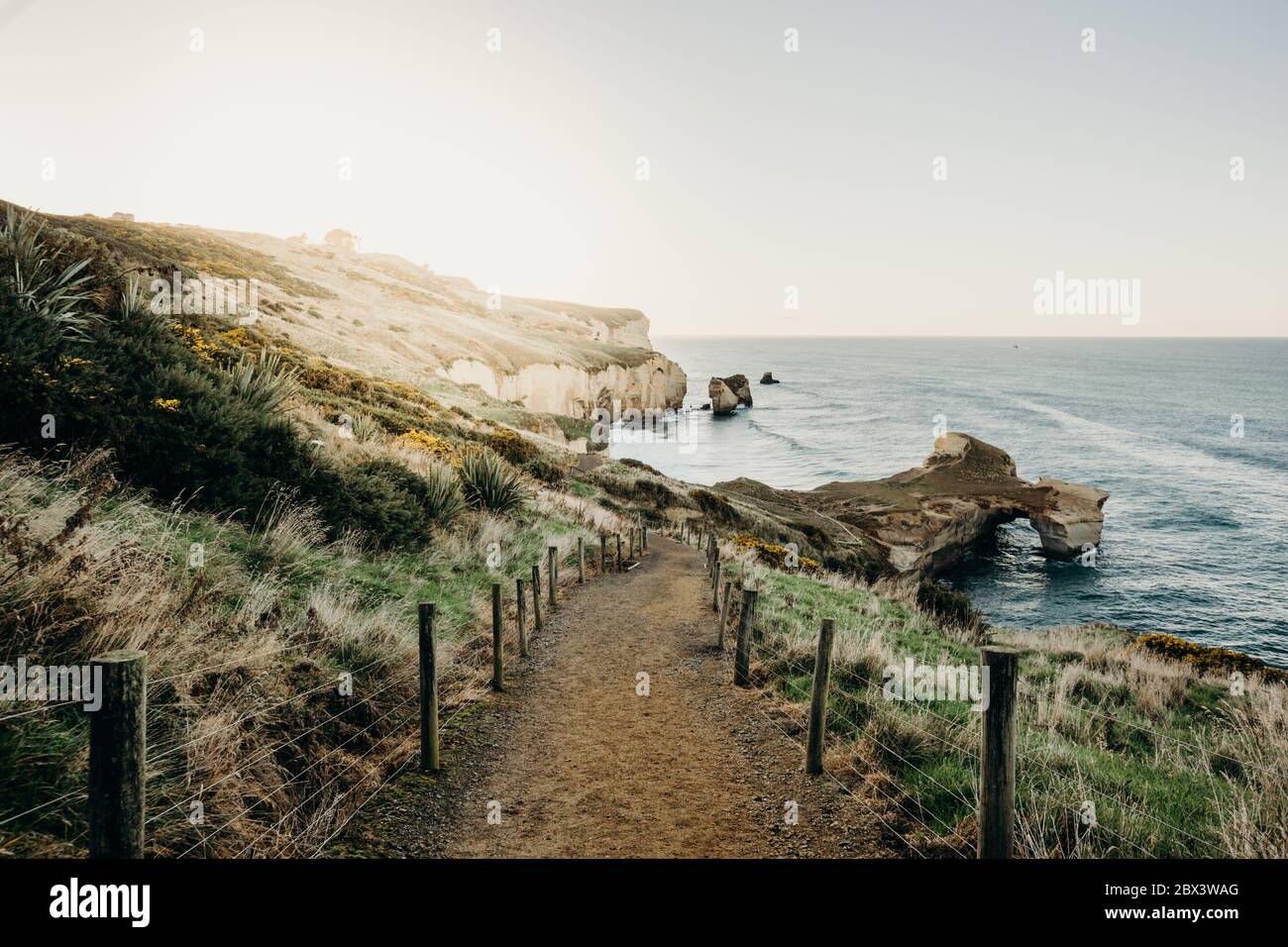 Beautiful sunrise with Natural arch at Tunnel beach, Otago Peninsula, New Zealand Stock Photo