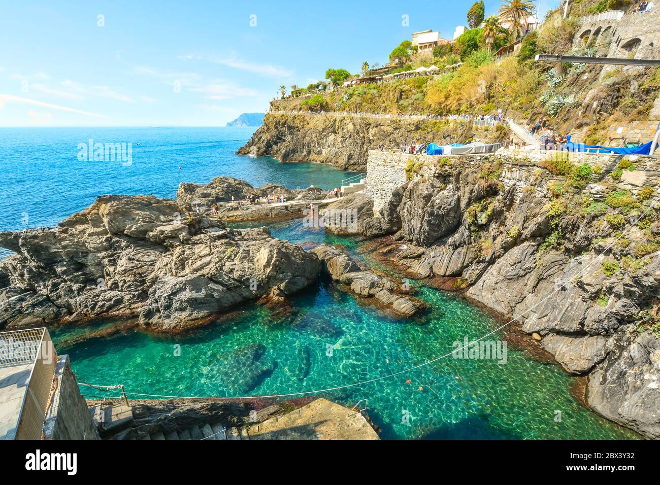 Small swimming lagoon on the rocky coast of the village of Manarola, on the Ligurian coast of Cinque Terre, Italy Stock Photo