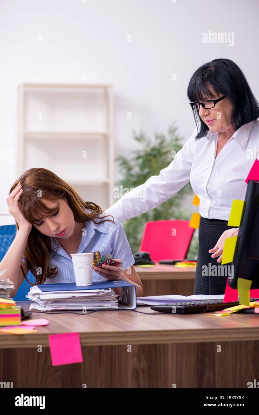 Two employees and excessive work in the office Stock Photo