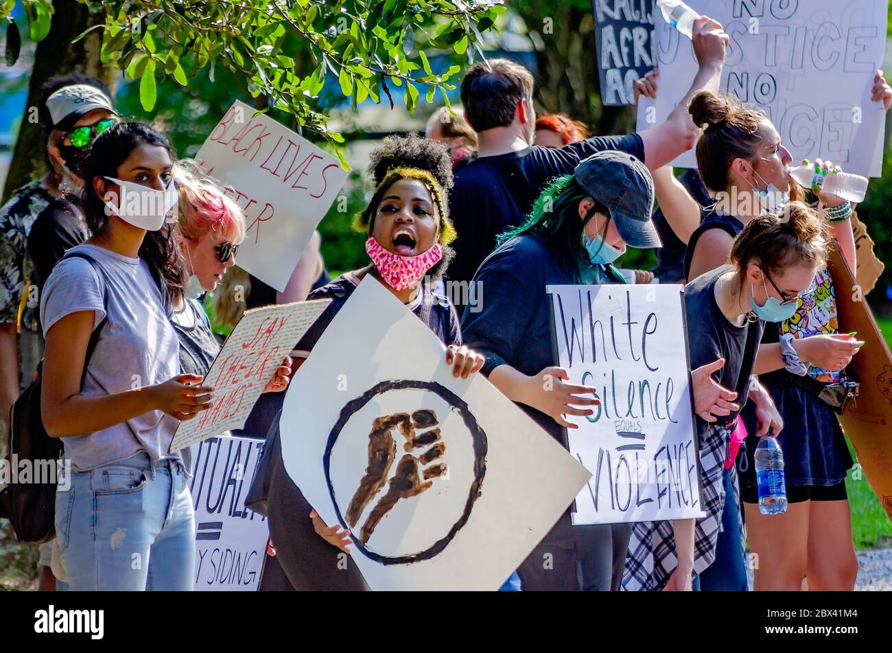 Protestors wave signs while at a protest against police brutality, June 4, 2020, at Memorial Park in Mobile, Alabama. Stock Photo