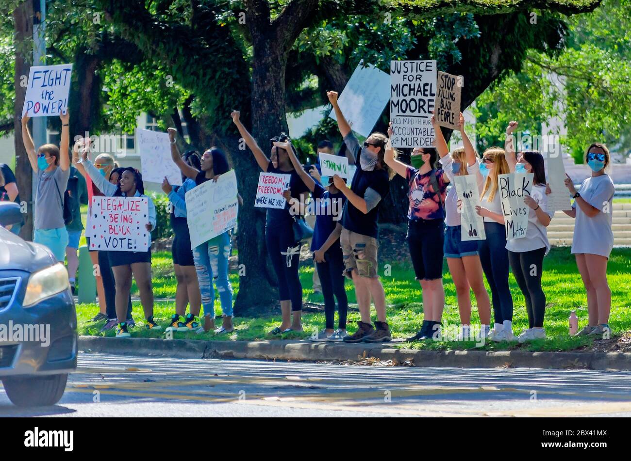 Protestors wave signs while at a protest against police brutality, June 4, 2020, at Memorial Park in Mobile, Alabama. Stock Photo