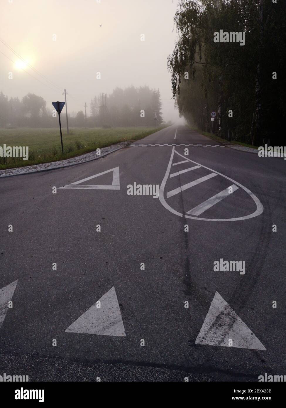 Empty misty early morning asphalt road in province Stock Photo