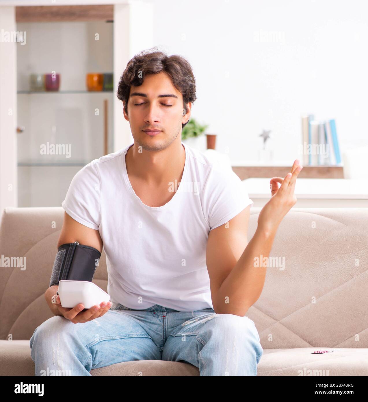 The young man measuring blood pressure at home Stock Photo - Alamy