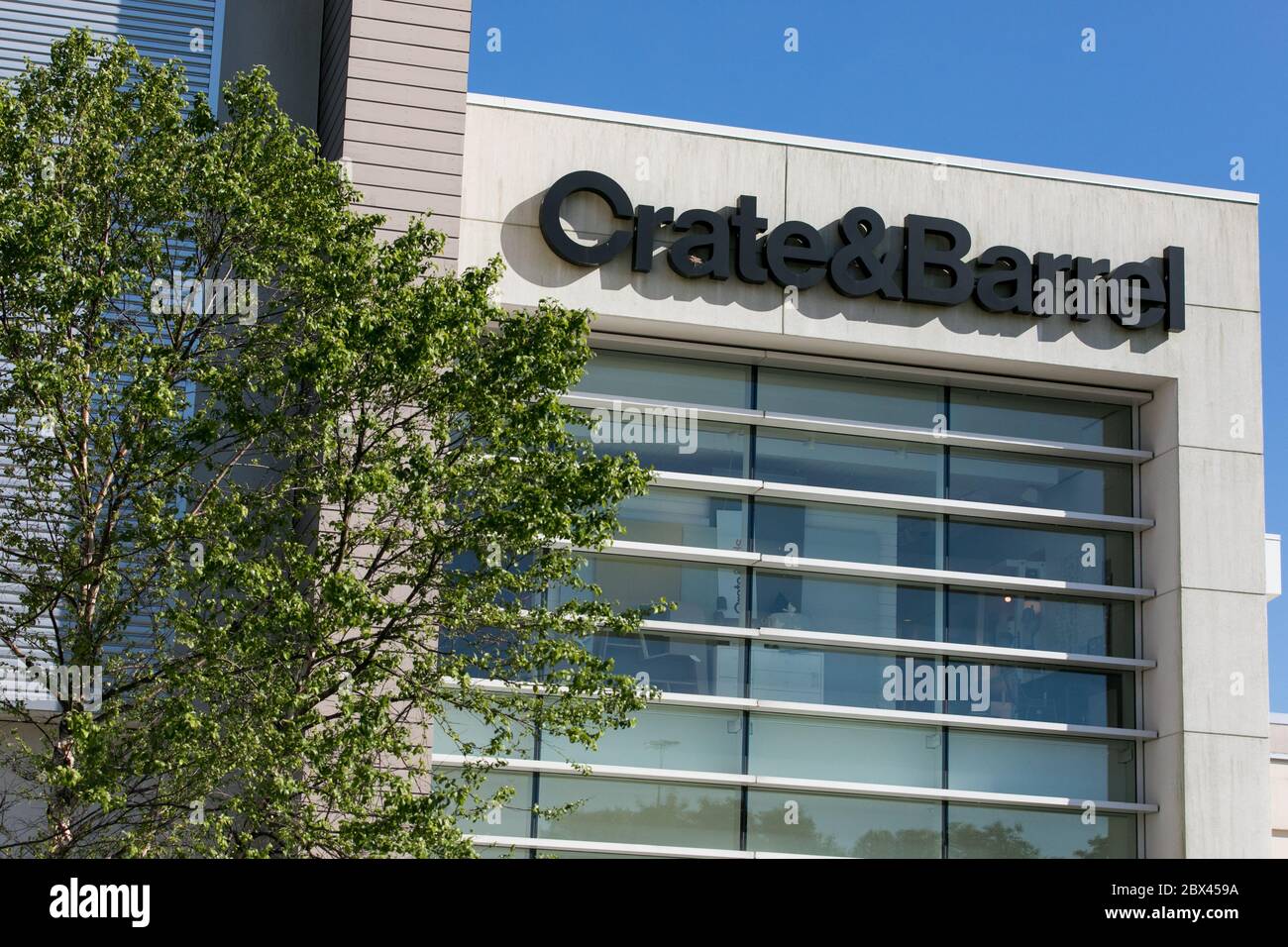 A logo sign outside of a Crate and Barrel retail store location in