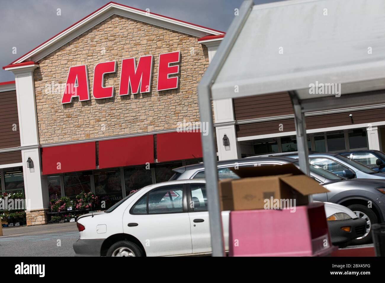 A logo sign outside of Acme retail grocery store location in