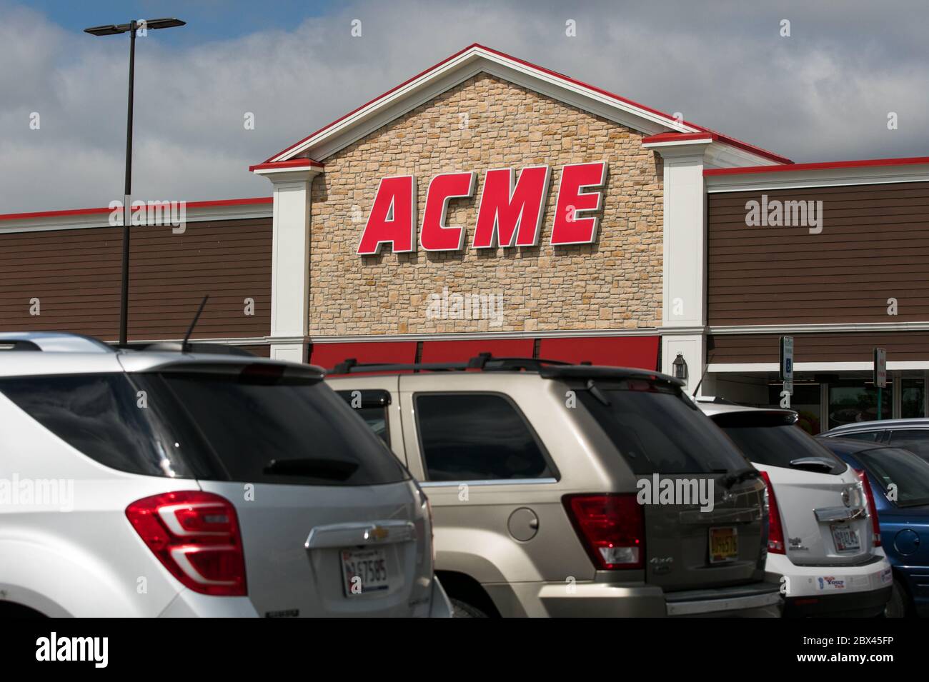 A logo sign outside of Acme retail grocery store location in