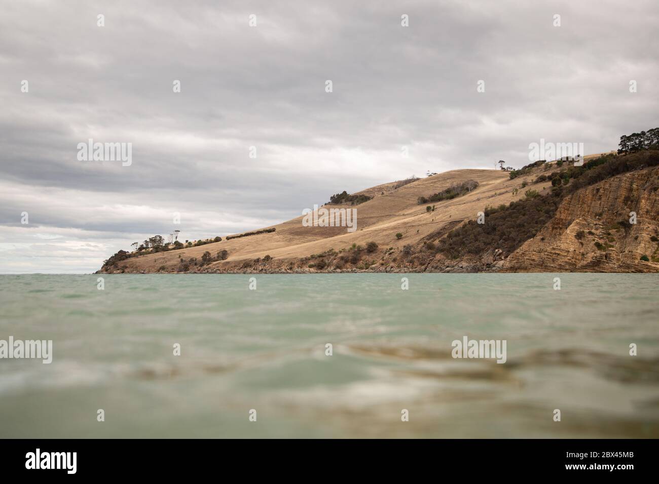 Water level view of Clifton Beach Headland South Arm Tasmania Australia