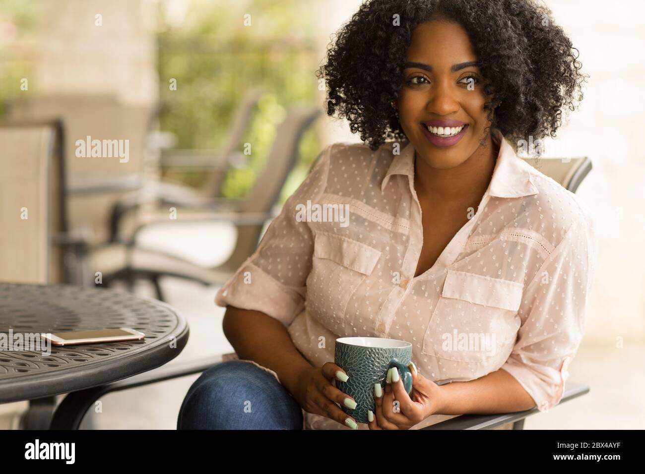 Portrait of an African American woman drinking coffee. Stock Photo