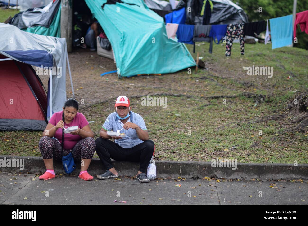Members of 'Pescador de Hombres' foundation bring good to Venezuelans stranded in a makeshift camp amid Covid-19 pandemic, waiting for an opportunity Stock Photo