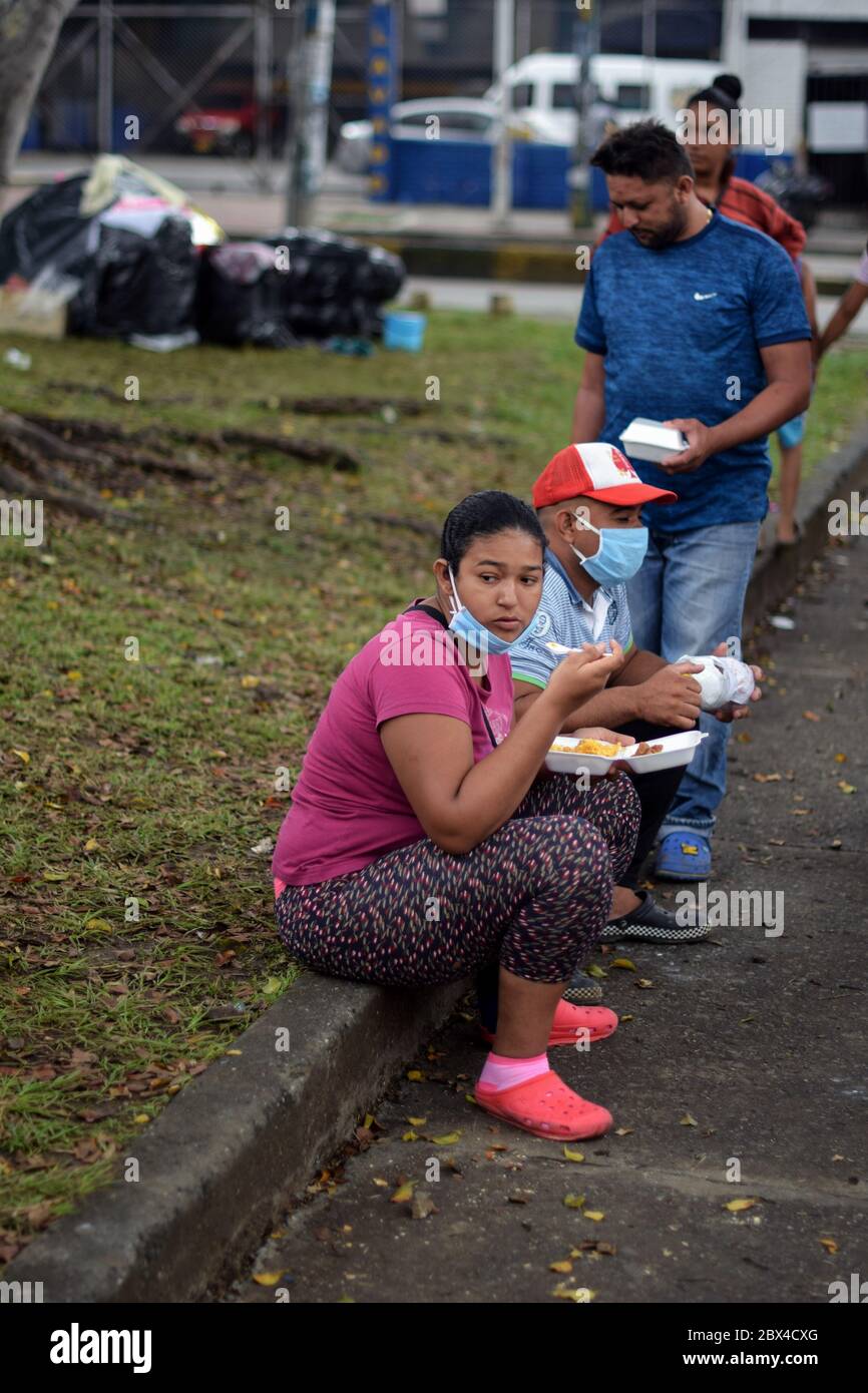 Members of 'Pescador de Hombres' foundation bring good to Venezuelans stranded in a makeshift camp amid Covid-19 pandemic, waiting for an opportunity Stock Photo