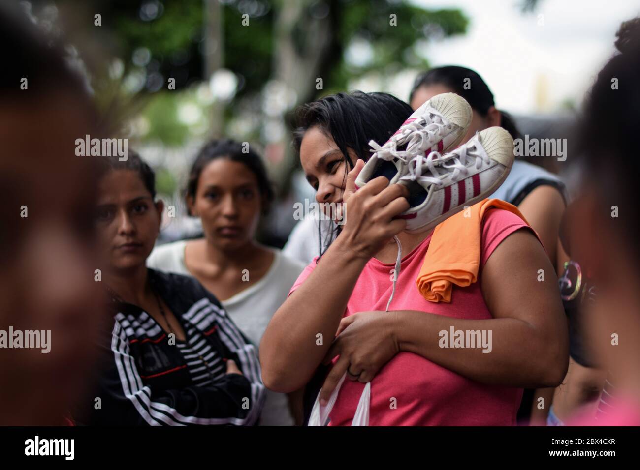 Group of stranded Venezuelan women gather to distribute privately donated clothes in the makeshift camp created amid Covid-19 pandemic, where they wai Stock Photo